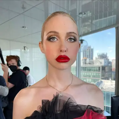 Chloe Cherry with a red lip and smokey frosted lid.