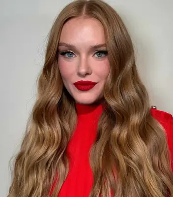 Abbey Cowen wears a bold red lip paired with black winged eyeliner and pink blush