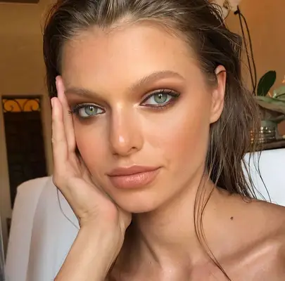 model wears subtle bronze eyeshadow and eyeliner