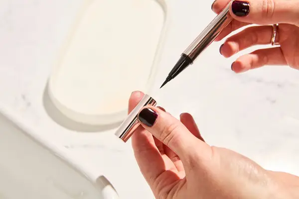 Person holds Fenty Beauty Flyliner Longwear Liquid Eyeliner in Cuz I