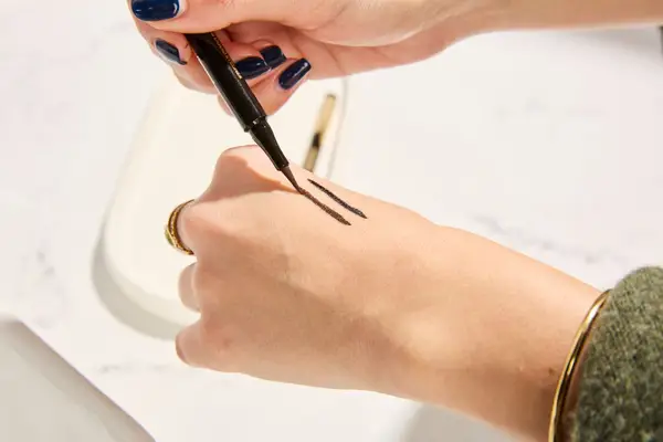 Person tests COVERGIRL Exhibitionist Lash Enhancing Liquid Eyeliner