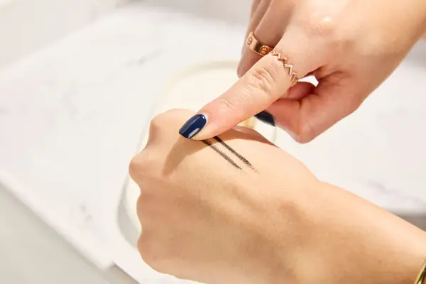 Person tests COVERGIRL Exhibitionist Lash Enhancing Liquid Eyeliner