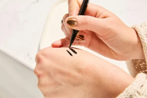 Person tests e.l.f. Cosmetics Intense H2O Proof Eyeliner Pen