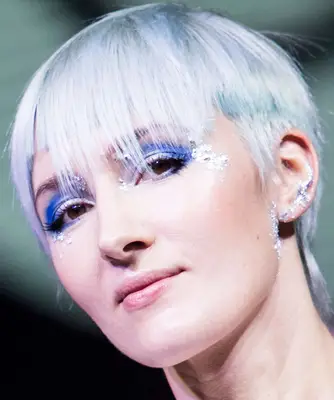 A shimmery ice blue makeup look on a young woman