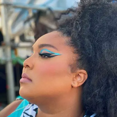 Lizzo wears abstract bold blue eyeshadow