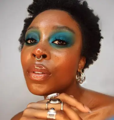 A woman models teal eyeshadow