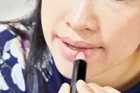 A person applies CTZN Cosmetics Nudiversal Lip Duo