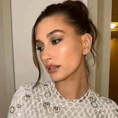 Makeup artist Sophia Vallejos wears a radiant bronzed makeup look with glossy jelly lips