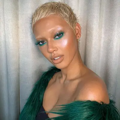 Model with emerald green eyeshadow smudged at top and bottom lash lines