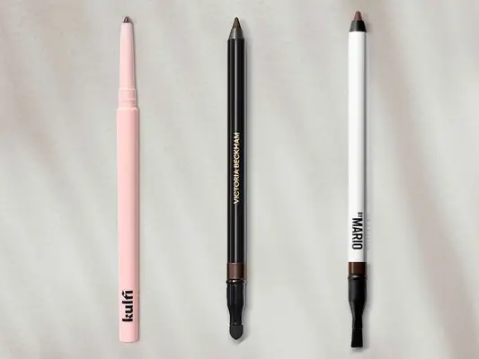 A side-by-side selection of brown eyeliners from Kulfi, Victoria Beckham, and Makeup By Mario on a gray background