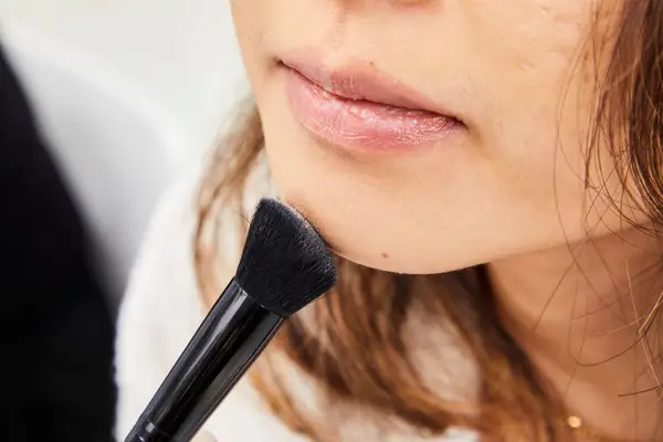 A person applies Anastasia Beverly Hills Powder Contour Kit powder