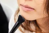 A person applies Anastasia Beverly Hills Powder Contour Kit powder