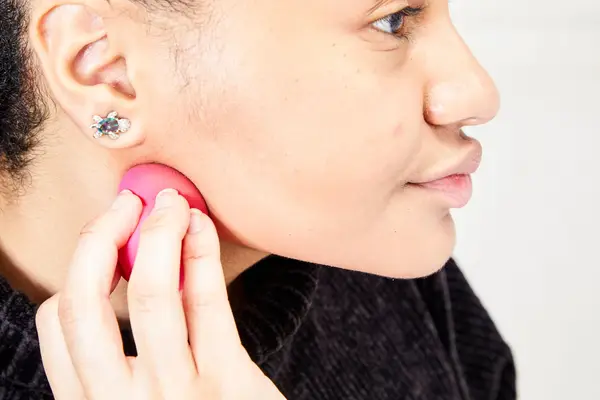 A person applies the Patrick Ta Major Sculpt Creme Contour & Powder Bronzer Duo