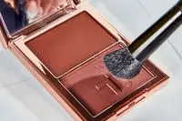 The Patrick Ta Major Sculpt Creme Contour & Powder Bronzer Duo is applies with a brush