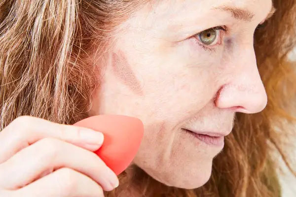 A person applies the NYX Professional Makeup Wonder Stick Contour & Highlighter Stick