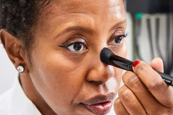 A person applies the Danessa Myricks Beauty Groundwork Defining Neutrals Palette