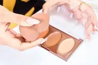 A person applies the COVERGIRL Trublend Contour Palette with a makeup sponge