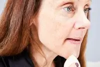 A person applies the KVD Beauty Shade + Light Powder Face Contour Palette