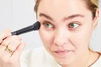 A person applies Charlotte Tilbury Filmstar Bronze & Glow Contour Duo