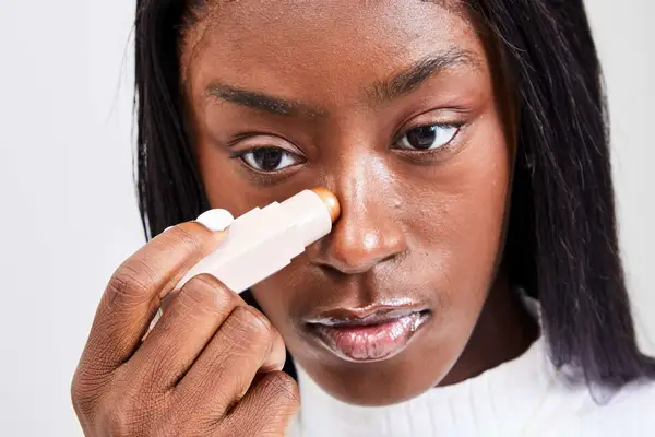 A person applies the Fenty Beauty Match Stix Duo Contour Highlighter
