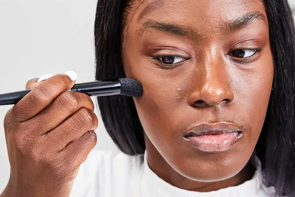 A person applies Fenty Beauty Match Stix Duo Contour Highlight Set