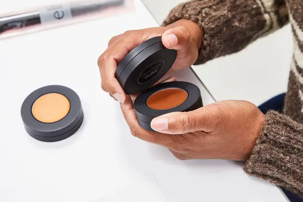 A person removes the top on the Melt Cosmetics The Sculpt Stack