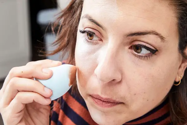 A person applies the Make Up For Ever HD Skin Cream Contour and Highlight Sculpting Palette