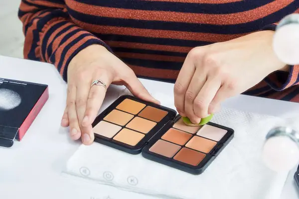 A person applies the Make Up For Ever HD Skin Cream Contour and Highlight Sculpting Palette