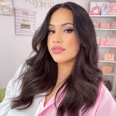 Woman with soft glam pink makeup look and curled blowout