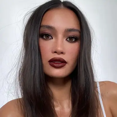Kelsey Merritt wears smoky eyeshadow and burgundy lipstick