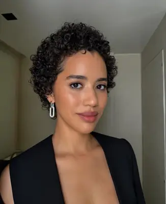 model wears bronzed makeup look with light berry lips