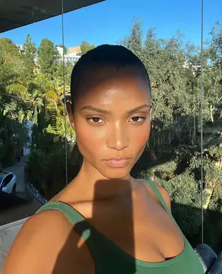 woman posing in sunlight wearing natural makeup