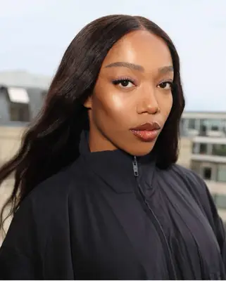 model poses wearing glam makeup look with glossy cranberry lips