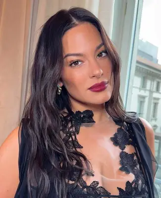 model wears soft makeup look with bold crimson red lip