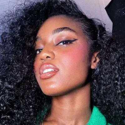 Model with Barbie pink blush, bat winged liner, and rose-toned lips