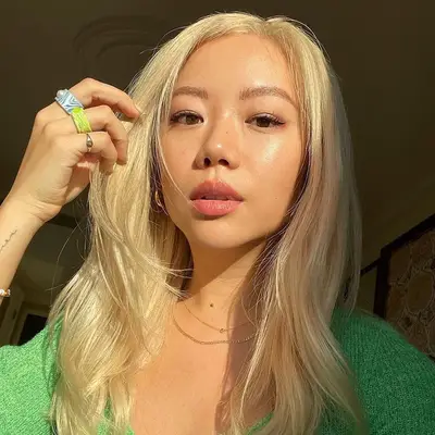 Former MYM Beauty editor Faith Xue wears a radiant makeup look with pink lipstick and long lashes