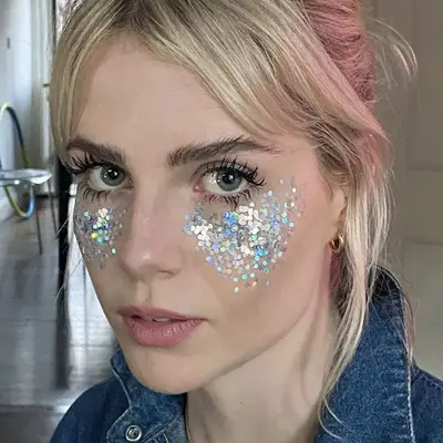 Lucy Boynton wears mascara and dramatic glitter under-eyes