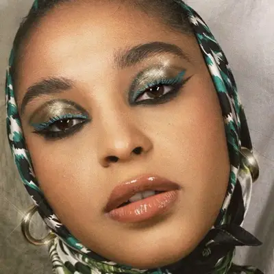 Green and blue smoky eye makeup with glitter