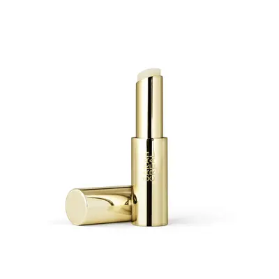 Gold lip balm container opened with lid next to it 