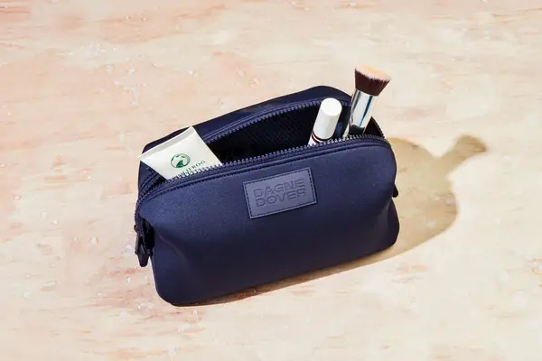 Dagne Dover Hunter Toiletry Bag sitting on a countertop filled with products