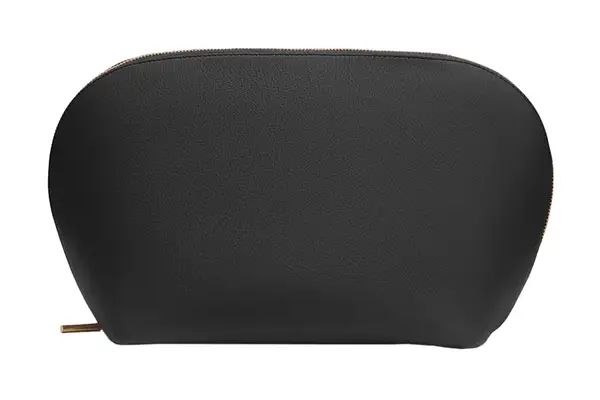 Hands placing a slip pocket containing makeup brushes into the Beis The Cosmetics Case