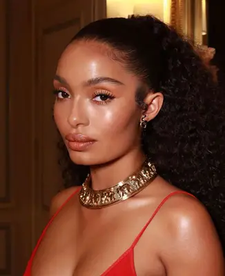 model poses wearing natural makeup look with nude eyeshadow, prominent eyeliner and mascara