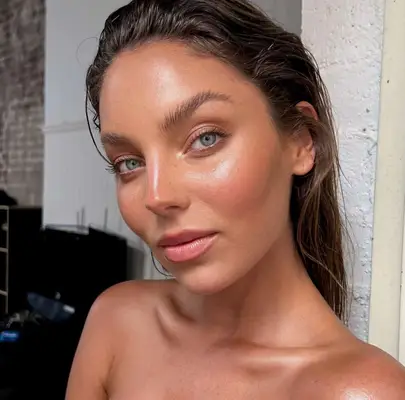 model wears nude eyeshadow look with a glowing complexion
