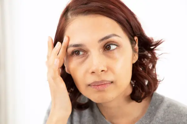 Person applying skincare product to face