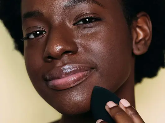 woman using a makeup sponge