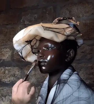 Model modelling the Maison Margiela Haute Couture Show with glazed glass skin by Pat McGrath