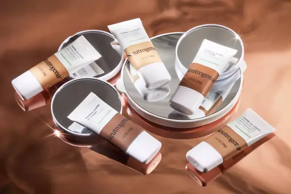 Hands opening Dermablend Continuous Correction Tone-Evening CC Cream with nearby makeup sponge