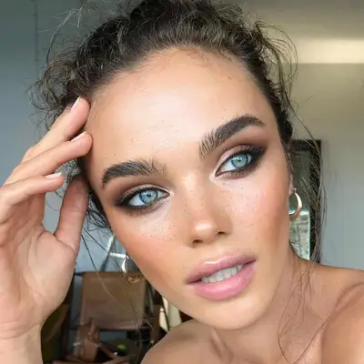 Woman with blue eyes and a smoky champagne eyeshadow look.