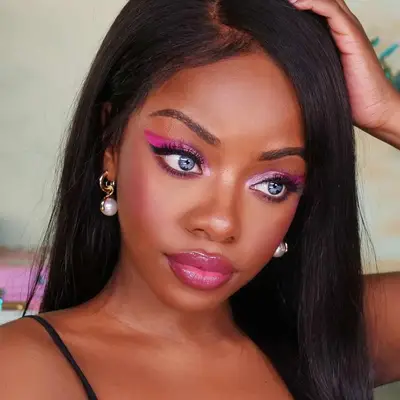 Woman with blue eyes and Barbie pink eyeshadow.