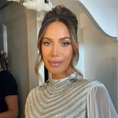 Woman with blue eyes and a shimmering gold eyeshadow.